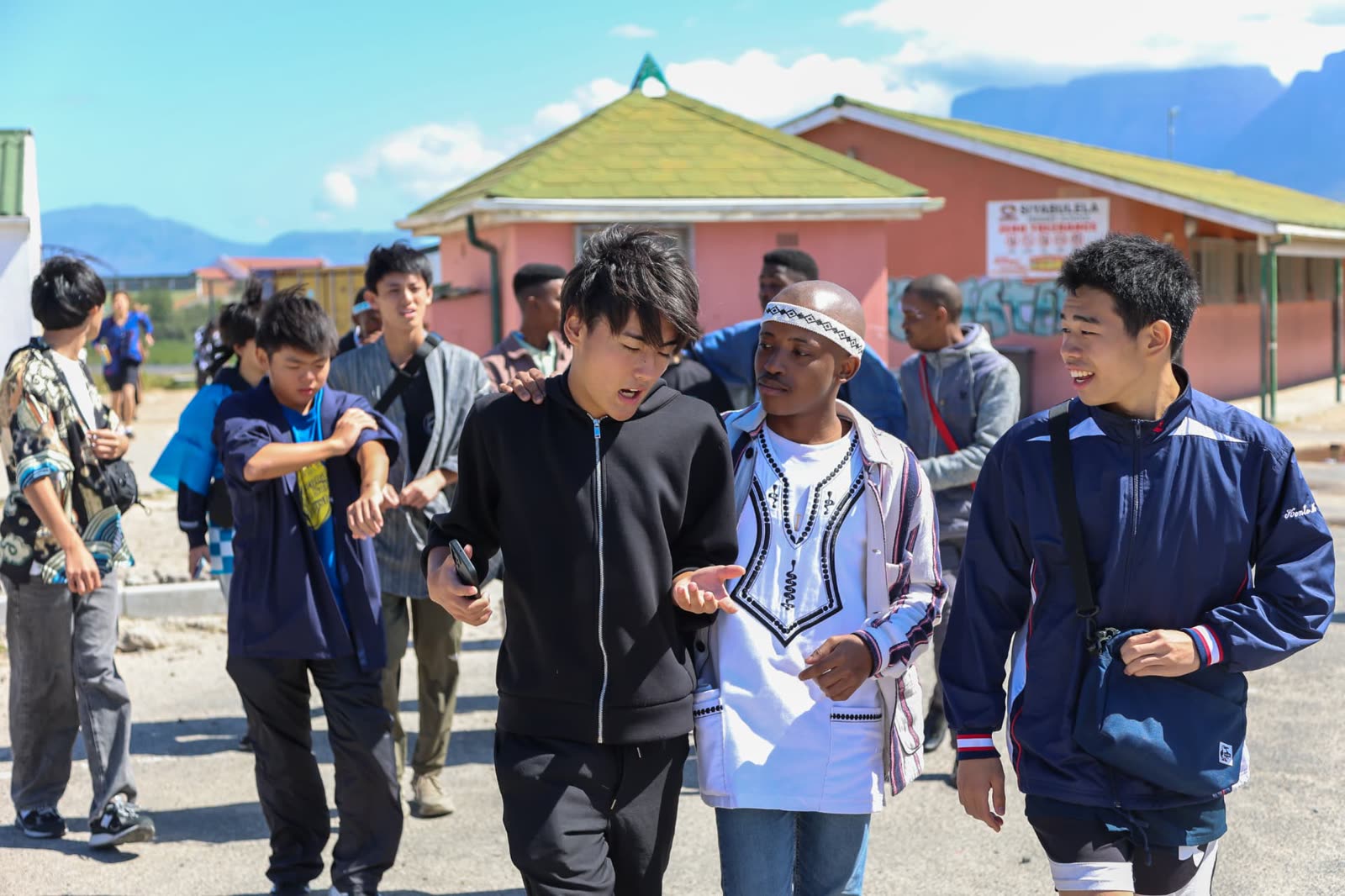 A facilitator walking through Langa with visiting exchange students